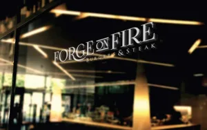 Forge on fire logo on restaurant Glass
